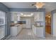 Kitchen with white cabinets, tile floors and stainless steel appliances at 4710 Parkdale Ln, New Port Richey, FL 34655