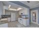 White kitchen with granite countertops and access to the backyard at 4710 Parkdale Ln, New Port Richey, FL 34655