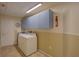 Laundry room with washer, dryer, and upper cabinets at 4710 Parkdale Ln, New Port Richey, FL 34655