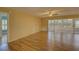 Bright living room with wood-look floors and sliding glass doors leading to a patio at 4710 Parkdale Ln, New Port Richey, FL 34655