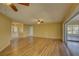 Spacious living room featuring wood-look floors and access to other rooms at 4710 Parkdale Ln, New Port Richey, FL 34655