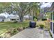 Private patio with grill, lush landscaping, and view of the backyard at 4710 Parkdale Ln, New Port Richey, FL 34655
