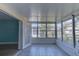 Spacious sunroom with large windows and tiled floors at 4710 Parkdale Ln, New Port Richey, FL 34655