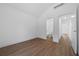 Bright bedroom with wood-look floors and ensuite bathroom at 5173 Pacific Ave, Spring Hill, FL 34607