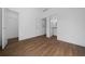 Bedroom offers wood-look floors and access to ensuite bathroom at 5173 Pacific Ave, Spring Hill, FL 34607