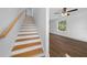 Bright staircase with wood treads and white risers, leading to the upper level at 5173 Pacific Ave, Spring Hill, FL 34607