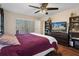 Bedroom with a king bed, TV, and built-in shelving at 5371 Joyner Ave, Spring Hill, FL 34608