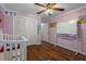bedroom with crib and white closet doors at 5371 Joyner Ave, Spring Hill, FL 34608