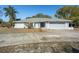 Single-story home with a two-car garage and landscaped yard at 5371 Joyner Ave, Spring Hill, FL 34608