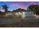 Attractive single-story home with a two-car garage at dusk at 5371 Joyner Ave, Spring Hill, FL 34608