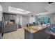 Modern kitchen with granite countertops, gray cabinets, and an island at 5371 Joyner Ave, Spring Hill, FL 34608