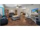 Open living room, dining area, and kitchen with hardwood floors at 5371 Joyner Ave, Spring Hill, FL 34608