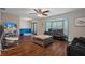 Spacious living room with hardwood floors, a cozy fireplace, and ample natural light at 5371 Joyner Ave, Spring Hill, FL 34608
