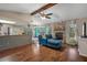Open living space with hardwood floors and a stone fireplace at 5371 Joyner Ave, Spring Hill, FL 34608