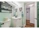 Updated bathroom with white vanity and a view of the hallway at 5557 Sea Forest Dr # 117, New Port Richey, FL 34652