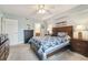 Spacious bedroom with a queen bed, dresser, and ceiling fan at 5557 Sea Forest Dr # 117, New Port Richey, FL 34652