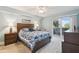 Bright bedroom with a queen-size bed and access to a private balcony at 5557 Sea Forest Dr # 117, New Port Richey, FL 34652