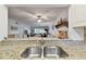 Kitchen with granite countertops, double sink, and open concept view at 5557 Sea Forest Dr # 117, New Port Richey, FL 34652