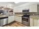 Updated kitchen featuring granite countertops and modern cabinetry at 5557 Sea Forest Dr # 117, New Port Richey, FL 34652
