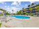 Relaxing community pool with lounge chairs and patio area at 5557 Sea Forest Dr # 117, New Port Richey, FL 34652