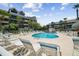 Community pool with plenty of lounge chairs at 5557 Sea Forest Dr # 117, New Port Richey, FL 34652