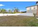 Large backyard with a white fence and patchy grass at 578 Argyll Dr, Spring Hill, FL 34609