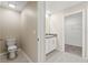 Clean bathroom with toilet, vanity, and walk-in closet at 578 Argyll Dr, Spring Hill, FL 34609