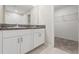 Double vanity bathroom with granite countertops and large mirror at 578 Argyll Dr, Spring Hill, FL 34609