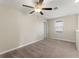 Comfortable bedroom with ceiling fan and window with blinds at 578 Argyll Dr, Spring Hill, FL 34609