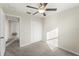 Bedroom with ceiling fan and access to hallway at 578 Argyll Dr, Spring Hill, FL 34609