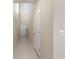 Bright entry hall with tile flooring, coat closet, and stairs at 578 Argyll Dr, Spring Hill, FL 34609