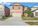 Two-story house with a tan exterior and a two-car garage at 578 Argyll Dr, Spring Hill, FL 34609