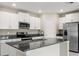 Modern kitchen with white cabinets, granite counters, and stainless steel appliances at 578 Argyll Dr, Spring Hill, FL 34609
