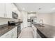 Modern kitchen with white cabinets, granite counters, and stainless steel appliances at 578 Argyll Dr, Spring Hill, FL 34609