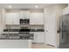 Modern kitchen with white cabinets and granite countertops at 578 Argyll Dr, Spring Hill, FL 34609