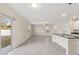 Open living room and kitchen with tile floor and sliding glass doors at 578 Argyll Dr, Spring Hill, FL 34609
