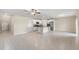 Open living room and kitchen area with tile floors and ceiling fan at 578 Argyll Dr, Spring Hill, FL 34609