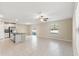 Open living room and kitchen area with tile floors and ceiling fan at 578 Argyll Dr, Spring Hill, FL 34609