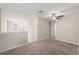 Spacious loft area with neutral carpeting and ceiling fan at 578 Argyll Dr, Spring Hill, FL 34609