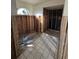 Bathroom under renovation, featuring new tile floors and a framed shower at 6116 Island Dr, Weeki Wachee, FL 34607