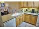 Modern kitchen with wood cabinets, stainless steel appliances, and a breakfast bar at 6801 Dali Ave # G104, Land O Lakes, FL 34637