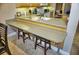 Breakfast bar with two stools, looking toward the kitchen at 6801 Dali Ave # G104, Land O Lakes, FL 34637