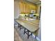 Kitchen features breakfast bar with wood cabinets and granite countertop at 6801 Dali Ave # G104, Land O Lakes, FL 34637