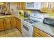 Modern kitchen with wood cabinets and stainless steel appliances at 6801 Dali Ave # G104, Land O Lakes, FL 34637