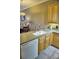 Modern kitchen with wood cabinets, stainless steel appliances, and a breakfast bar at 6801 Dali Ave # G104, Land O Lakes, FL 34637