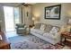 Living room features a sofa, armchair, and access to a patio at 6801 Dali Ave # G104, Land O Lakes, FL 34637