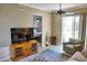 Living room with TV, seating, and view into bedroom at 6801 Dali Ave # G104, Land O Lakes, FL 34637