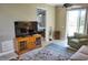 Living room with TV, seating, and view into bedroom at 6801 Dali Ave # G104, Land O Lakes, FL 34637