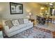 Living room with sofa and view into dining area at 6801 Dali Ave # G104, Land O Lakes, FL 34637