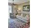Living room features a sofa, armchair, and access to a patio at 6801 Dali Ave # G104, Land O Lakes, FL 34637